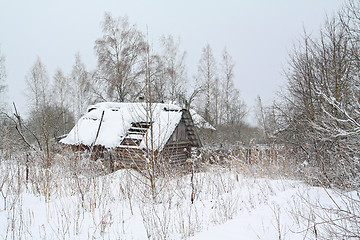 Image showing old rural house amongst white snow