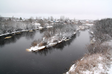 Image showing snow village on coast river 