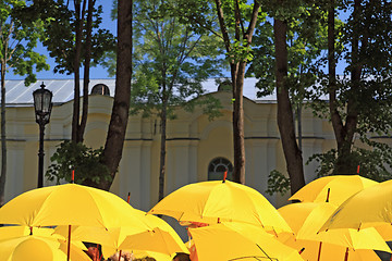 Image showing yellow umbrellas on town street