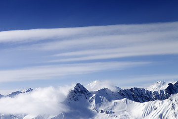 Image showing High mountains in haze and blue sky with clouds