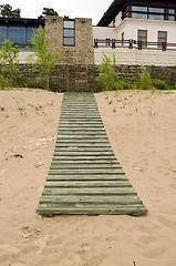 Image showing Seaside wooden plank path house weaven fence 