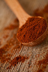 Image showing ground red pepper in wooden spoon 