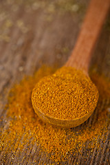 Image showing curry powder in wooden spoon 