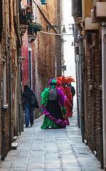 Image showing Venetian Costumes Walking on a Narrow Street in Venice