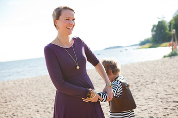 Image showing Mother and son at beach.