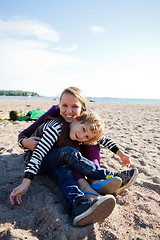 Image showing Mother and son at beach.