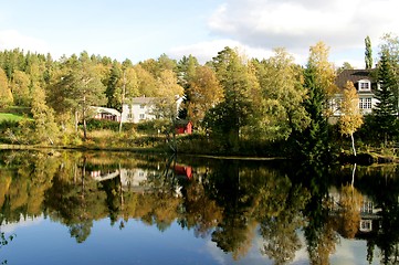 Image showing Villas by a dam