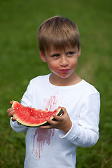 Image showing Child eating a watermelon