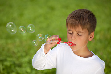 Image showing Little boy having fun with bubbles