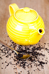 Image showing yellow teapot with spoon