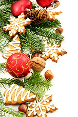 Image showing Christmas toys, fir branches and ginger biscuits.