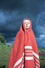 Image showing The girl wrapped in a red blanket