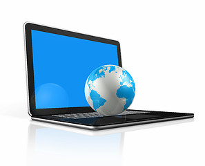 Image showing World globe, map on a laptop