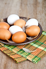 Image showing eggs in a plate, towel and feathers