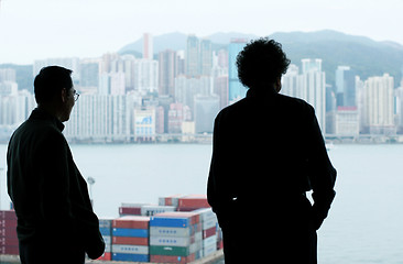 Image showing Two businessmen looking out of the window