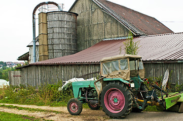 Image showing old barn with silo and tractor