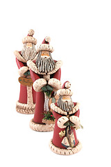 Image showing Three Santa figures isolated