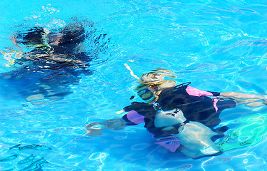 Image showing Scuba divers in blue water