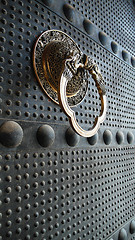 Image showing Ancient iron door with a copper doorknob