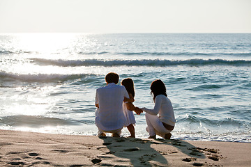 Image showing happy young family with daughter on beach in summer