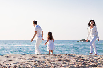 Image showing happy young family with daughter on beach in summer