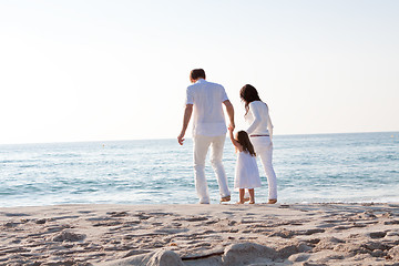 Image showing happy young family with daughter on beach in summer