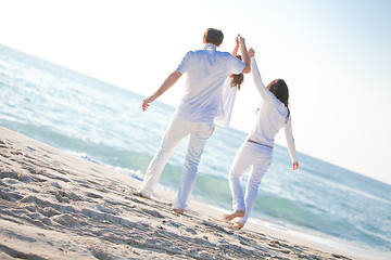 Image showing happy young family with daughter on beach in summer