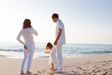 Image showing happy young family with daughter on beach in summer