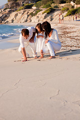 Image showing happy young family with daughter on beach in summer