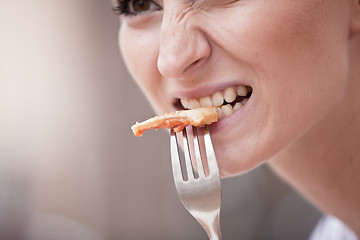 Image showing young woman is eating a pizza in restaurant