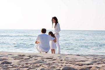 Image showing happy young family with daughter on beach in summer