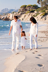 Image showing happy young family with daughter on beach in summer