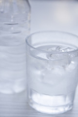 Image showing fresh cold clear mineral water in bottle and glass on table