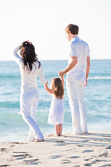 Image showing happy young family with daughter on beach in summer