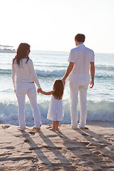 Image showing happy young family with daughter on beach in summer