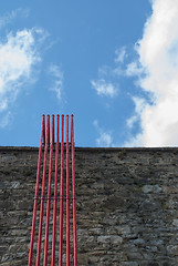 Image showing Stone Wall With Red Pipes