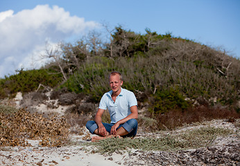 Image showing young man is relaxing outdoor in dune in summer