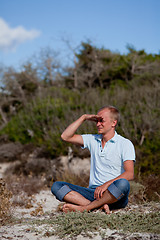 Image showing young man is relaxing outdoor in dune in summer