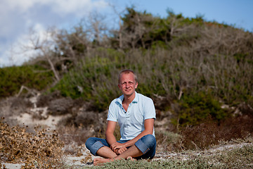 Image showing young man is relaxing outdoor in dune in summer