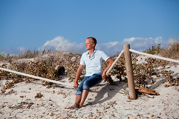 Image showing young man is relaxing outdoor in dune in summer