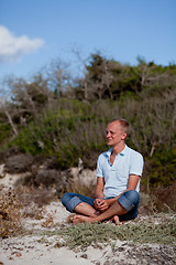 Image showing young man is relaxing outdoor in dune in summer