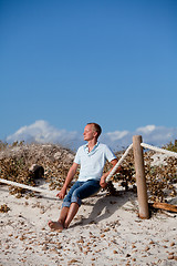 Image showing young man is relaxing outdoor in dune in summer