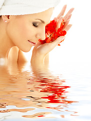 Image showing lady with red petals in water