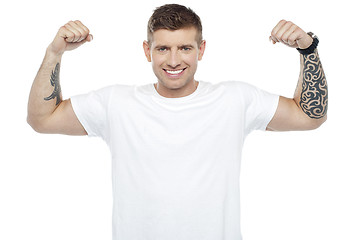 Image showing Muscular handsome young man showing his biceps
