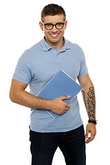 Image showing Modern college student holding notebook