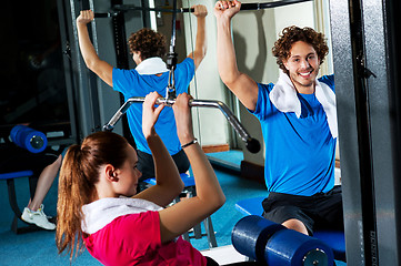 Image showing Friends working out together in a multi gym