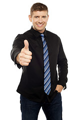 Image showing Smart young executive showing thumbs up