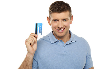 Image showing Cheerful man holding credit card