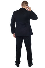 Image showing Back pose of young male security person