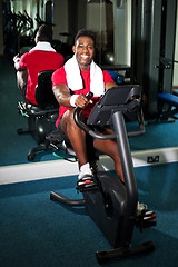 Image showing Young guy burning calories, pedaling fast